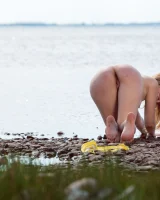 Stripping yellow bikini at the sea