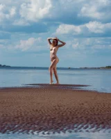 Stripping yellow bikini at the sea