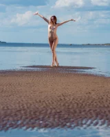 Stripping yellow bikini at the sea
