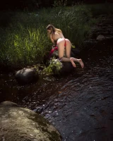 Hot girl in red bikini is nude in the forest river