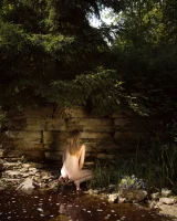 Hot girl in red bikini is nude in the forest river