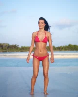 Puffy nipples passionate brunette in red bikini strips in the lake water