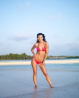 Puffy nipples passionate brunette in red bikini strips in the lake water