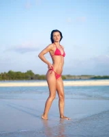 Puffy nipples passionate brunette in red bikini strips in the lake water