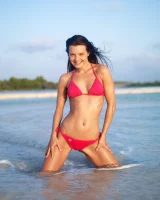 Puffy nipples passionate brunette in red bikini strips in the lake water