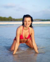 Puffy nipples passionate brunette in red bikini strips in the lake water