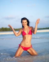 Puffy nipples passionate brunette in red bikini strips in the lake water