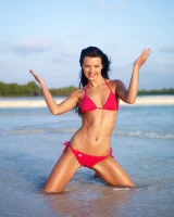 Puffy nipples passionate brunette in red bikini strips in the lake water