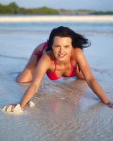 Puffy nipples passionate brunette in red bikini strips in the lake water