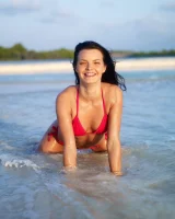 Puffy nipples passionate brunette in red bikini strips in the lake water