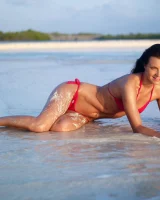 Puffy nipples passionate brunette in red bikini strips in the lake water