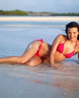 Puffy nipples passionate brunette in red bikini strips in the lake water