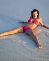 Puffy nipples passionate brunette in red bikini strips in the lake water