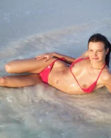 Puffy nipples passionate brunette in red bikini strips in the lake water