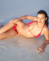 Puffy nipples passionate brunette in red bikini strips in the lake water