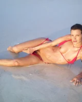 Puffy nipples passionate brunette in red bikini strips in the lake water