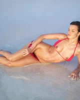 Puffy nipples passionate brunette in red bikini strips in the lake water