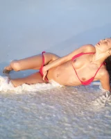 Puffy nipples passionate brunette in red bikini strips in the lake water