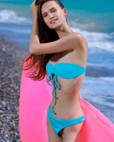 Young playful puffy nipples brunette baby in blue bikini goes nude on the beach on toy float