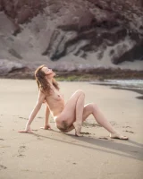 Perfect body girl in black bikini is nude on the beach with erected nipples