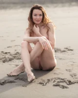 Perfect body girl in black bikini is nude on the beach with erected nipples