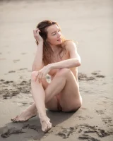 Perfect body girl in black bikini is nude on the beach with erected nipples