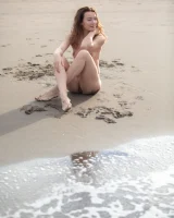 Perfect body girl in black bikini is nude on the beach with erected nipples