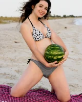 Pretty brunette teen is on the beach in grey bikini with watermelon, she strips her remarkable perfect puffy nipples body