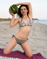 Pretty brunette teen is on the beach in grey bikini with watermelon, she strips her remarkable perfect puffy nipples body