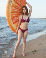 Sexy busty fresh body girl in bikini is nude on the beach