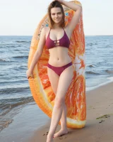 Sexy busty fresh body girl in bikini is nude on the beach