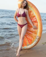 Sexy busty fresh body girl in bikini is nude on the beach