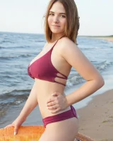 Sexy busty fresh body girl in bikini is nude on the beach