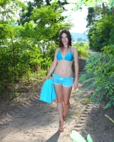 Sexy brunette rests at the lake side in blue bikini and nude afterwards