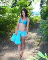 Sexy brunette rests at the lake side in blue bikini and nude afterwards