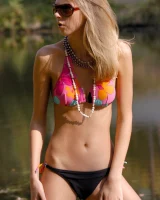 Perfect young girl is by the lake in bikini and walking nude in the lake