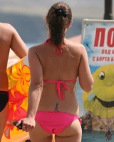 Candid girls in bikini walking on the beach