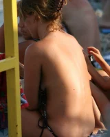 Candid girls in bikini walking on the beach