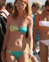Candid girls in bikini walking on the beach