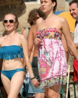 Candid girls in bikini walking on the beach