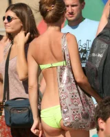 Candid girls in bikini walking on the beach