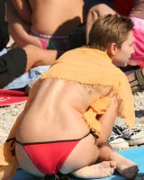 Candid girls in bikini walking on the beach