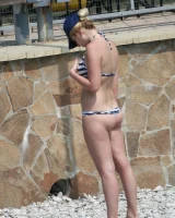 Candid girl on the beach and walking nearby in sexy bikinis