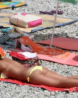 Candid girl on the beach and walking nearby in sexy bikinis
