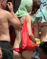 Candid girl on the beach and walking nearby in sexy bikinis