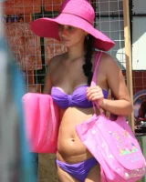 Candid girl on the beach and walking nearby in sexy bikinis