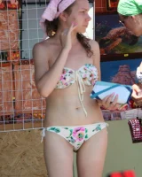 Candid girl on the beach and walking nearby in sexy bikinis