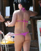 Candid girl on the beach and walking nearby in sexy bikinis