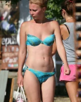 Candid girl on the beach and walking nearby in sexy bikinis