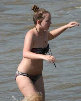 Candid girl on the beach and walking nearby in sexy bikinis